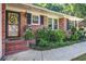 Cozy brick porch with charming decor and well-maintained landscaping at 1126 Brigantine Dr, Charleston, SC 29412