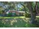 Charming brick home with lush landscaping and mature trees offering shade at 1126 Brigantine Dr, Charleston, SC 29412