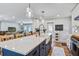 Well-lit kitchen island with a navy blue base, stainless steel appliances, and open to the living spaces at 1126 Brigantine Dr, Charleston, SC 29412