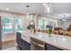 Bright kitchen showcases a large island with a white farmhouse sink, stainless steel appliances, and pendant lights at 1126 Brigantine Dr, Charleston, SC 29412