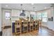 Stylish kitchen with a breakfast bar featuring wooden chairs, stainless steel appliances, and modern countertops at 1126 Brigantine Dr, Charleston, SC 29412