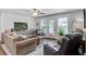 Cozy living room featuring a neutral sofa, recliner chairs and a view to the outside through the glass door at 1126 Brigantine Dr, Charleston, SC 29412