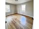 Sunlit bedroom with hardwood floors and two bright windows at 114 Madison St, Walterboro, SC 29488