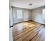 Bright bedroom with hardwood flooring and sunlight shining through the windows at 114 Madison St, Walterboro, SC 29488