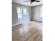 Bedroom showcasing two windows, hardwood floors, and a ceiling fan at 114 Madison St, Walterboro, SC 29488