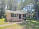 Charming single-story brick home featuring classic design, black shutters, and a well-manicured front yard at 114 Madison St, Walterboro, SC 29488