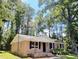 Charming single-story brick home with a manicured lawn and surrounded by lush trees at 114 Madison St, Walterboro, SC 29488