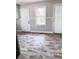 Inviting eat-in kitchen boasts trendy floors, white wainscoting, and ample natural light at 114 Madison St, Walterboro, SC 29488