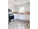 Bright kitchen features modern appliances, butcher block countertops, white cabinetry, and new floors at 114 Madison St, Walterboro, SC 29488