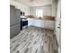Bright kitchen features modern appliances, butcher block countertops, white cabinetry, and new floors at 114 Madison St, Walterboro, SC 29488