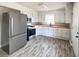 Bright kitchen features modern appliances, butcher block countertops, white cabinetry, and new floors at 114 Madison St, Walterboro, SC 29488