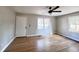 Bright living room with hardwood floors, fresh paint, new ceiling fan, and large windows at 114 Madison St, Walterboro, SC 29488