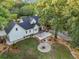 Aerial shot of the home's backyard showcasing a fire pit, wooden deck, and well-manicured lawn at 1260 Old Whitesville Rd, Moncks Corner, SC 29461