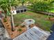 Aerial view showcasing home's backyard with a stone firepit, three car garage and a swing set at 1260 Old Whitesville Rd, Moncks Corner, SC 29461