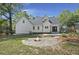 Inviting backyard featuring a stone fire pit and wooden deck, surrounded by lush greenery at 1260 Old Whitesville Rd, Moncks Corner, SC 29461