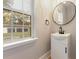 Bright bathroom featuring a white vanity and a window with an outdoor view at 1260 Old Whitesville Rd, Moncks Corner, SC 29461