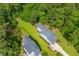 Aerial view of two-story home featuring mature trees, fenced yard and concrete driveway at 129 Martins Point Dr, Wando, SC 29492