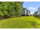 Spacious backyard with lush green grass and surrounding mature trees at 129 Martins Point Dr, Wando, SC 29492