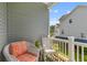 Cozy balcony view with wicker chairs and a glimpse of the neighborhood at 129 Martins Point Dr, Wando, SC 29492