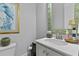 Well-lit powder room featuring a modern sink, stylish mirror, and neutral color palette at 129 Martins Point Dr, Wando, SC 29492
