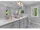 Bright bathroom with dual sinks, vanity, a large mirror and a separate tiled shower at 129 Martins Point Dr, Wando, SC 29492