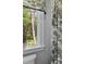 Bathroom with a toilet and view from a window with patterned curtain and potted plant at 129 Martins Point Dr, Wando, SC 29492