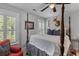 Bedroom features a four-poster bed, neutral walls, and natural light, creating a cozy atmosphere at 129 Martins Point Dr, Wando, SC 29492