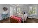 Bright bedroom with a white metal bed frame, desk, and stylish decor at 129 Martins Point Dr, Wando, SC 29492