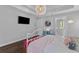 Stylish bedroom featuring a white bed, modern lighting, and a glimpse into ensuite bath at 129 Martins Point Dr, Wando, SC 29492