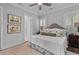 Cozy bedroom with plantation shutters, a ceiling fan, and neutral decor at 129 Martins Point Dr, Wando, SC 29492