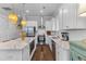 Bright, airy kitchen with stainless steel appliances, island, and white cabinetry at 129 Martins Point Dr, Wando, SC 29492