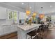 Stylish kitchen with island seating, pendant lighting, and views into the adjoining living space at 129 Martins Point Dr, Wando, SC 29492