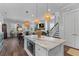 Open-concept kitchen featuring a large island, modern lighting, and seamless flow to living areas at 129 Martins Point Dr, Wando, SC 29492