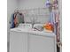 A laundry room featuring a washer, dryer, storage shelf, and ample space for organization and convenience at 129 Martins Point Dr, Wando, SC 29492