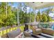 Relaxing screened porch featuring plush seating and serene backyard views at 129 Martins Point Dr, Wando, SC 29492