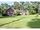 Charming brick home with manicured lawn and mature trees, offering classic curb appeal and a welcoming atmosphere at 1457 Green Pond Hwy, Walterboro, SC 29488