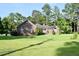 Inviting brick home featuring lush landscaping and a well-maintained lawn, creating a picturesque and serene setting at 1457 Green Pond Hwy, Walterboro, SC 29488