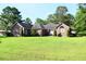 Beautiful brick home with a neatly trimmed lawn, showcasing its traditional architecture and serene surroundings at 1457 Green Pond Hwy, Walterboro, SC 29488