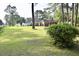 Spacious yard with lush green grass, mature trees providing ample shade, and charming landscaping at 1457 Green Pond Hwy, Walterboro, SC 29488