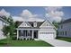 Charming home with gray siding, black shutters, and a two-car garage, complemented by a lush green lawn at 149 Seaton St, Summerville, SC 29486