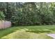 Spacious backyard with lush green grass and a wooded area, perfect for outdoor activities and privacy at 153 Instructor Ct, Ladson, SC 29456