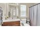 Bright bathroom with a white vanity, large mirror, and shower, offering a clean and functional space at 153 Instructor Ct, Ladson, SC 29456