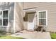 Inviting entryway with a small patio set, white door, and a well-lit window, providing a warm welcome at 153 Instructor Ct, Ladson, SC 29456