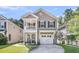 Inviting two-story home featuring a cozy front porch and attached one car garage at 153 Instructor Ct, Ladson, SC 29456