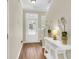 View of the foyer, showing the wood floors, staircase, and console table at 153 Instructor Ct, Ladson, SC 29456