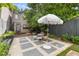A quaint backyard area with stone and gravel ground cover, a patio dining set, and green grass at 176 Smith St, Charleston, SC 29403