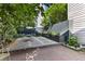 A beautifully landscaped backyard features a stone patio, dining set, and well-maintained garden at 176 Smith St, Charleston, SC 29403