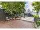 Secluded backyard featuring brick patio, trees, and outdoor dining area at 176 Smith St, Charleston, SC 29403