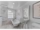 Elegant bathroom featuring a clawfoot tub, marble tile, and a stylish pedestal sink at 176 Smith St, Charleston, SC 29403