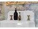 Elegant bathroom sink with vintage-style brass faucet and stylish wallpaper at 176 Smith St, Charleston, SC 29403